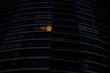© Jeff Wasserman/Stocksy - Home Alone: Night View of Condo Building - One Light On