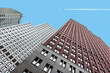© Vaidas Bucys/Stocksy - Modern skyscrapers with airplane trail
