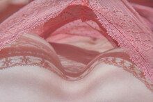 delicate breasts in pink lace underwear closeup