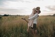 © Liliya Rodnikova/Stocksy - Young couple hugging in field