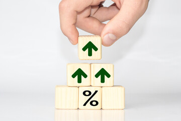 hand holding a cube with a symbol to increase rating with Percentage growth. Copy space for text or headline