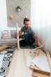 © David Prado/Stocksy - Focused man installing table at home