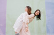 © Pansfun Images/Stocksy - funny portrait of two fashionable women