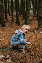 A Beautiful Blond Toddler In A Forest