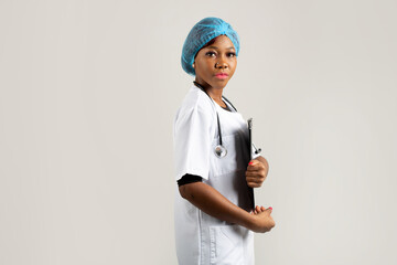 beautiful young african woman in a medical gown on a white background 