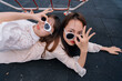 © Pansfun Images/Stocksy - funny portrait of two fashionable women