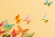 © Maki Company Limited/Stocksy - Paper colorful butterflies fly on wall in different directions