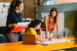 © MyMicrostock/Stocksy - Businesswomen looking at blueprints in an office