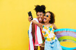 © BONNINSTUDIO/Stocksy - Funny black mother and daughter taking selfie in summer
