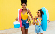 Ethnic Woman With Daughter Walking To Beach