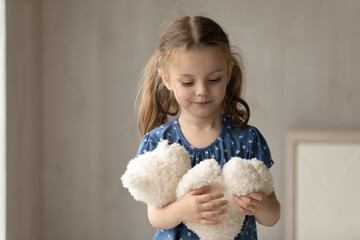 cute little 7s girl kid hold fluffy animal toy have fun engaged in playful activity at home on weeke