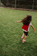 © AD Photography/Stocksy - Girl running with her red cape