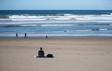 sitting on the beach looking at the sea