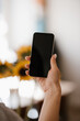 © Alina Hvostikova/Stocksy - Unrecognizable woman with smartphone in hand
