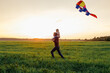 © Sergey Narevskih/Stocksy - Father and kid having fun with kite in field