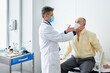 © ALTO IMAGES/Stocksy - Doctor examining a man