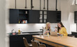 © Hernandez & Sorokina/Stocksy - Two Women Working At Office Kitchen