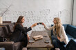 © Hernandez & Sorokina/Stocksy - Friends Meeting In Cozy Cafeteria
