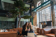 © Hernandez & Sorokina/Stocksy - Two Women Working In The Lobby