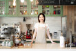 © MaaHoo Studio/Stocksy - Young cafeteria waitress standing in counter