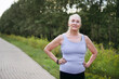 © Irina Polonina/Stocksy - Senior woman is resting in the park after a run.
