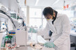 © Hernandez & Sorokina/Stocksy - Researcher In High Protection Working At Laboratory