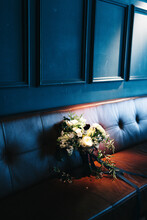 Wedding Bouquet On A Hidden Bench At Indoor Wedding Venue
