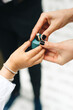 © Melissa Milis Photography/Stocksy - close up of kid giving the wedding ring to the bride