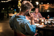 © Nunez Image/Stocksy - Young man Using Phone at Restaurant