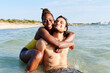 © Ivan Gener/Stocksy - Woman hugging her boyfriend at the beach