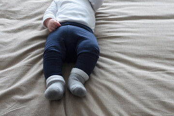 detail a baby dressed lying on the bed