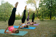 © Ivan Ozerov/Stocksy - four women in sportswear doing balance pose in the park