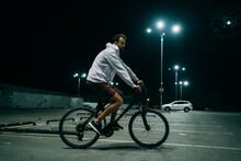 Man Rides On Bicycle At Night