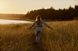 © Caleb MacKenzie Gaskins/Stocksy - Woman Walking in Field