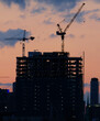 © Jeff Wasserman/Stocksy - Construction Cranes at Twilight