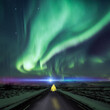 © plpictures by Paedii Luchs/Stocksy - Surreal northern lights road scene