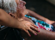© MyMicrostock/Stocksy - Elderly person being cared for by a young woman