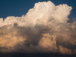 © Stas Pylypets/Stocksy - Large cumulus cloud at sunset