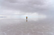 © Bisual Studio/Stocksy - Back view of a man reflected in Uyuni's salt flat in Bolivia