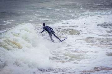 Wall Mural - Surfer on La Concha Bay in San Sebastian city also known as Donostia, Spain