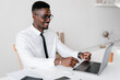 © Alina Hvostikova/Stocksy - Manager using laptop at desk
