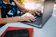 © MyMicrostock/Stocksy - From above unrecognizable old woman using laptop