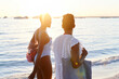 © Ivan Gener/Stocksy - Two women walking along a beach at dusk