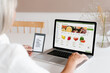 © Alina Hvostikova/Stocksy - Woman making online order of fruits on laptop