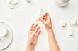 © 365mm/Stocksy - Crop woman applying cream on hands