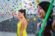 © Manu Prats/Stocksy - Women with resistance band training near climbing wall