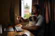 © Shikhar Bhattarai/Stocksy - Young man with his pug working from home.