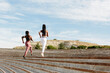 © Jimena Roquero/Stocksy - Back of Two Young woman jogging on concrete stairs