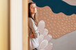 © Milles Studio/Stocksy - Young woman resting near painted wall