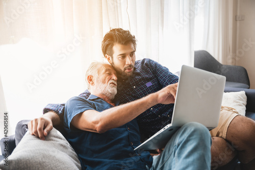 senior father hugging adult son, aged father and hipster son living together at home, hug and happy relation lifestyle, fatherhood activity indoor at the house, 2 man person family elderly generation